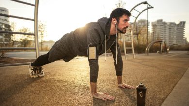 Man in Gray Jacket Doing Push-Ups During Sunrise